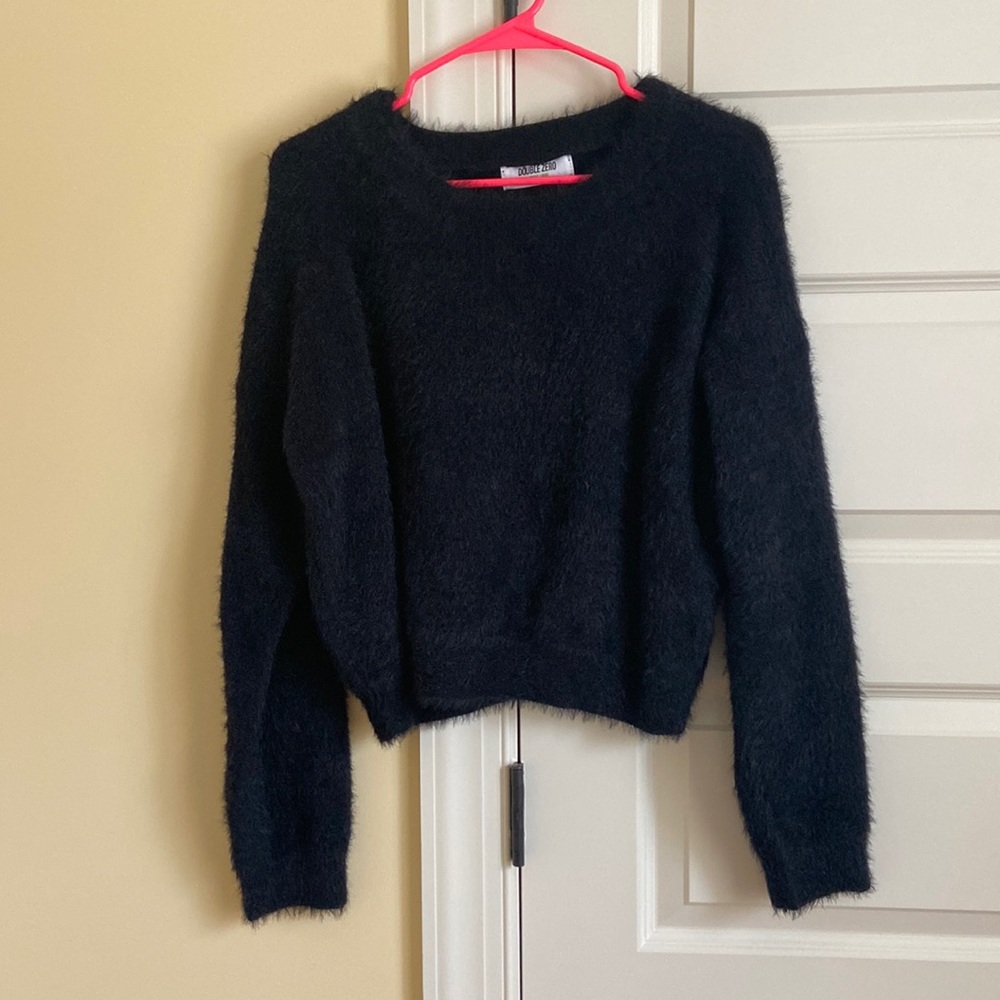 Brand is Double Zero. Warm and cozy black fuzzy sweater. Great quality!